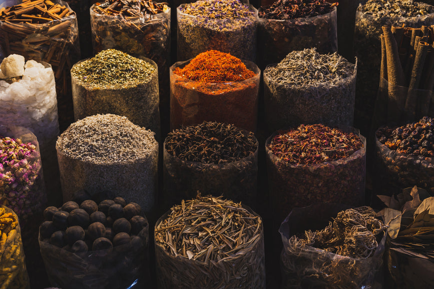 Rows of spices in baskets at a market
