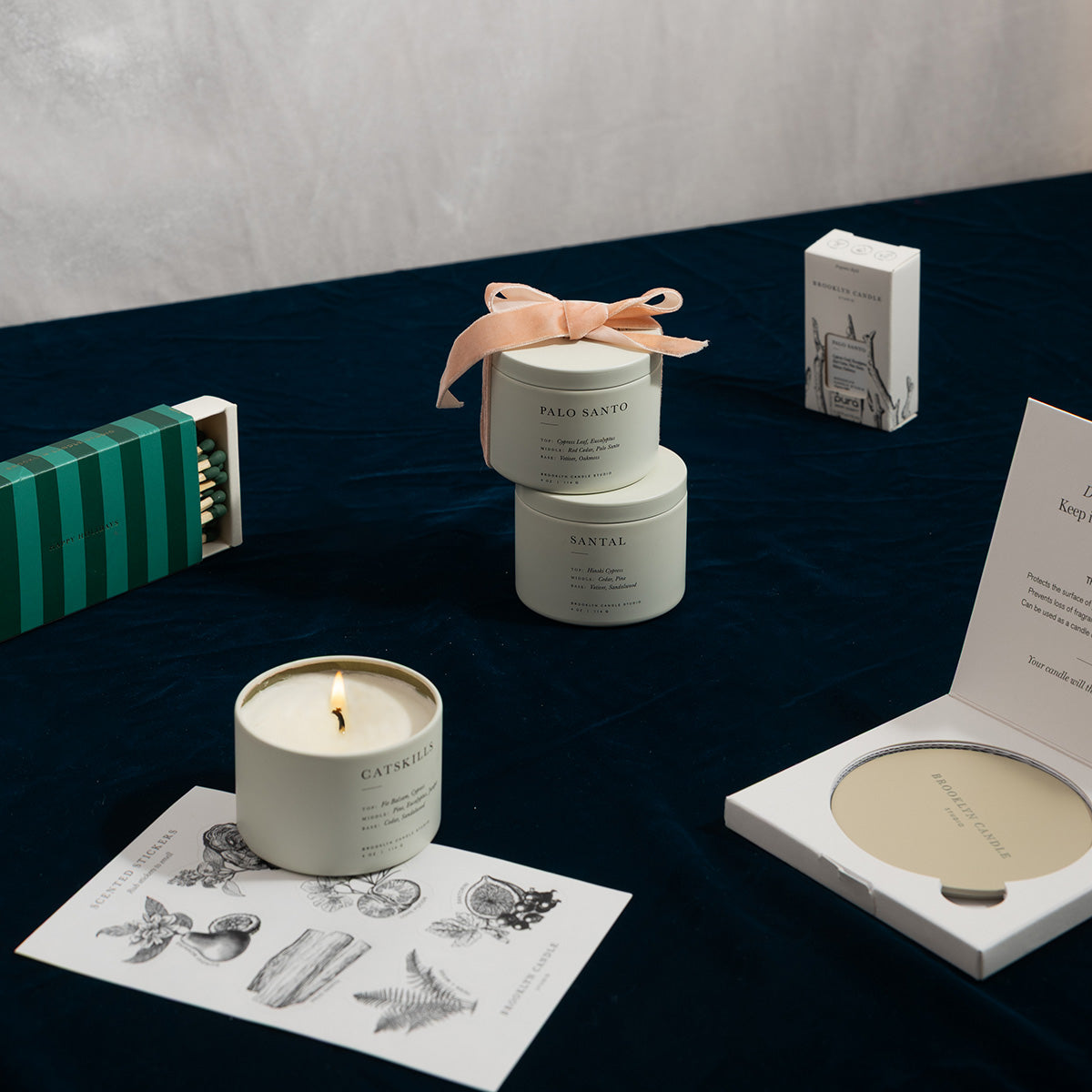 Candle, Matches, and other accessories on a dark surface with a white background